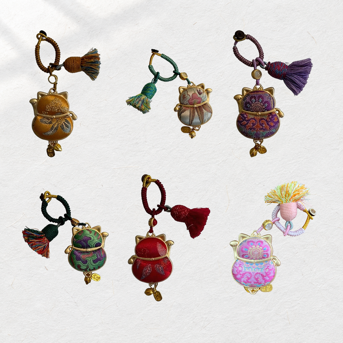 Six JOFAE Maneki Neko brocade charms in their original colors