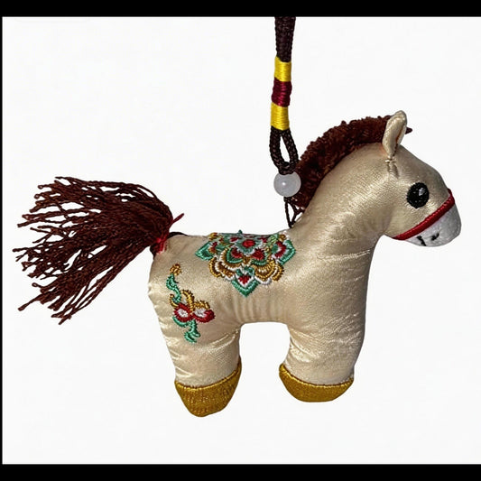 Hand-embroidered ivory Lucky Horse Charm by JOFAE Kyoto, a traditional Japanese amulet symbolizing safe journey and protection.
