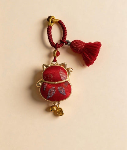 Red Maneki Neko lucky charm by JOFAE Kyoto, traditional Japanese handmade amulet symbolizing wealth, prosperity, and good fortune.