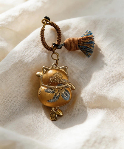 Yellow Maneki Neko lucky charm by JOFAE Kyoto, handmade ceramic amulet symbolizing wealth, success, and abundance.