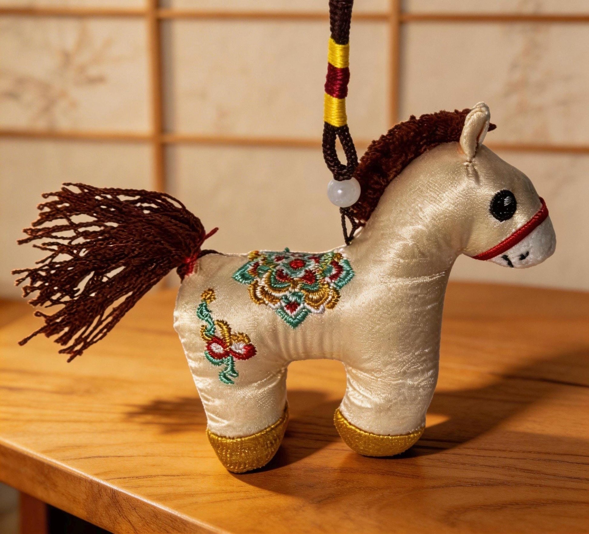 Kyoto-inspired ivory lucky horse charm by JOFAE Kyoto, hand-embroidered Japanese amulet symbolizing protection and safe journeys