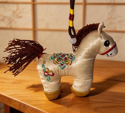 Kyoto-inspired ivory lucky horse charm by JOFAE Kyoto, hand-embroidered Japanese amulet symbolizing protection and safe journeys
