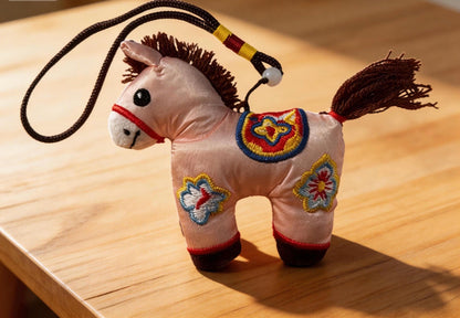 Pink Lucky Horse Charm from JOFAE Kyoto, handmade amulet symbolizing love, kindness, and emotional warmth, with traditional Kyoto craft style.