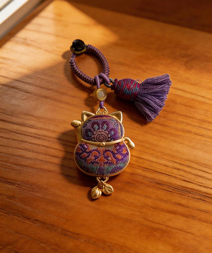 Purple Maneki Neko Lucky Charm by JOFAE Kyoto, handmade Japanese amulet symbolizing protection, wisdom, and inner balance.