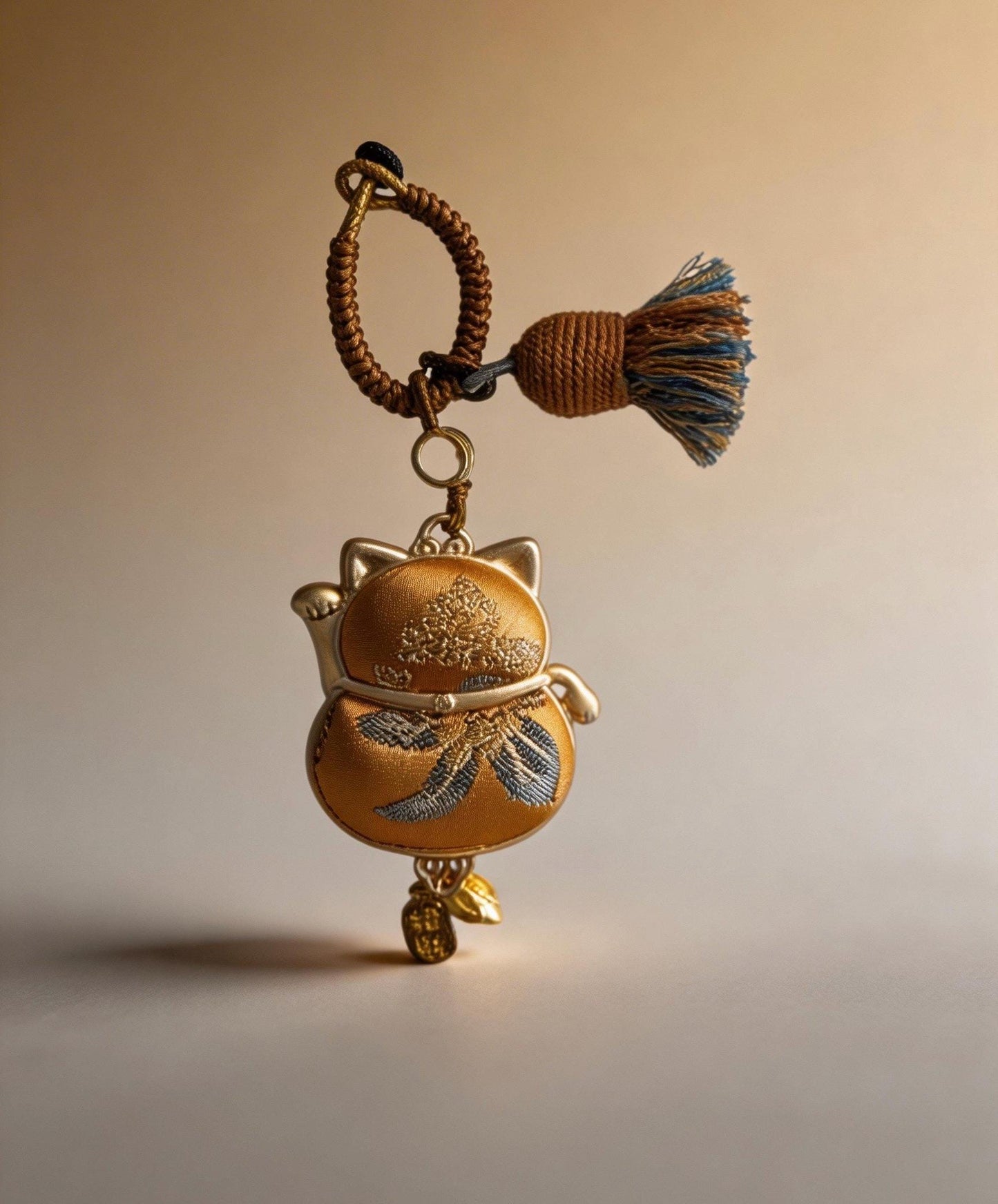 Yellow Maneki Neko lucky charm from JOFAE Kyoto, handmade amulet symbolizing wealth, success, and abundance in Japanese craft style.