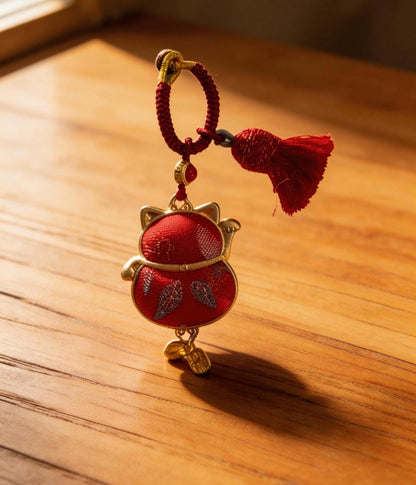 Red Maneki Neko lucky charm by JOFAE Kyoto, traditional Japanese amulet symbolizing wealth, prosperity, and good fortune.