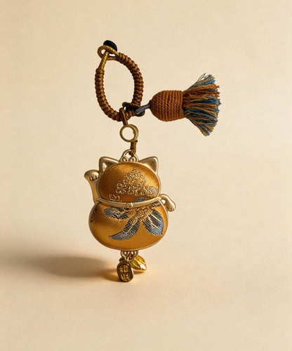 Yellow Maneki Neko Lucky Charm from JOFAE Kyoto, handmade amulet symbolizing wealth, success, and abundance in traditional artisan craft.