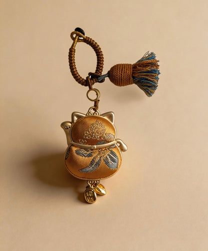 Yellow Maneki Neko Lucky Charm by JOFAE Kyoto, handmade artisan amulet symbolizing wealth, success, and abundance.