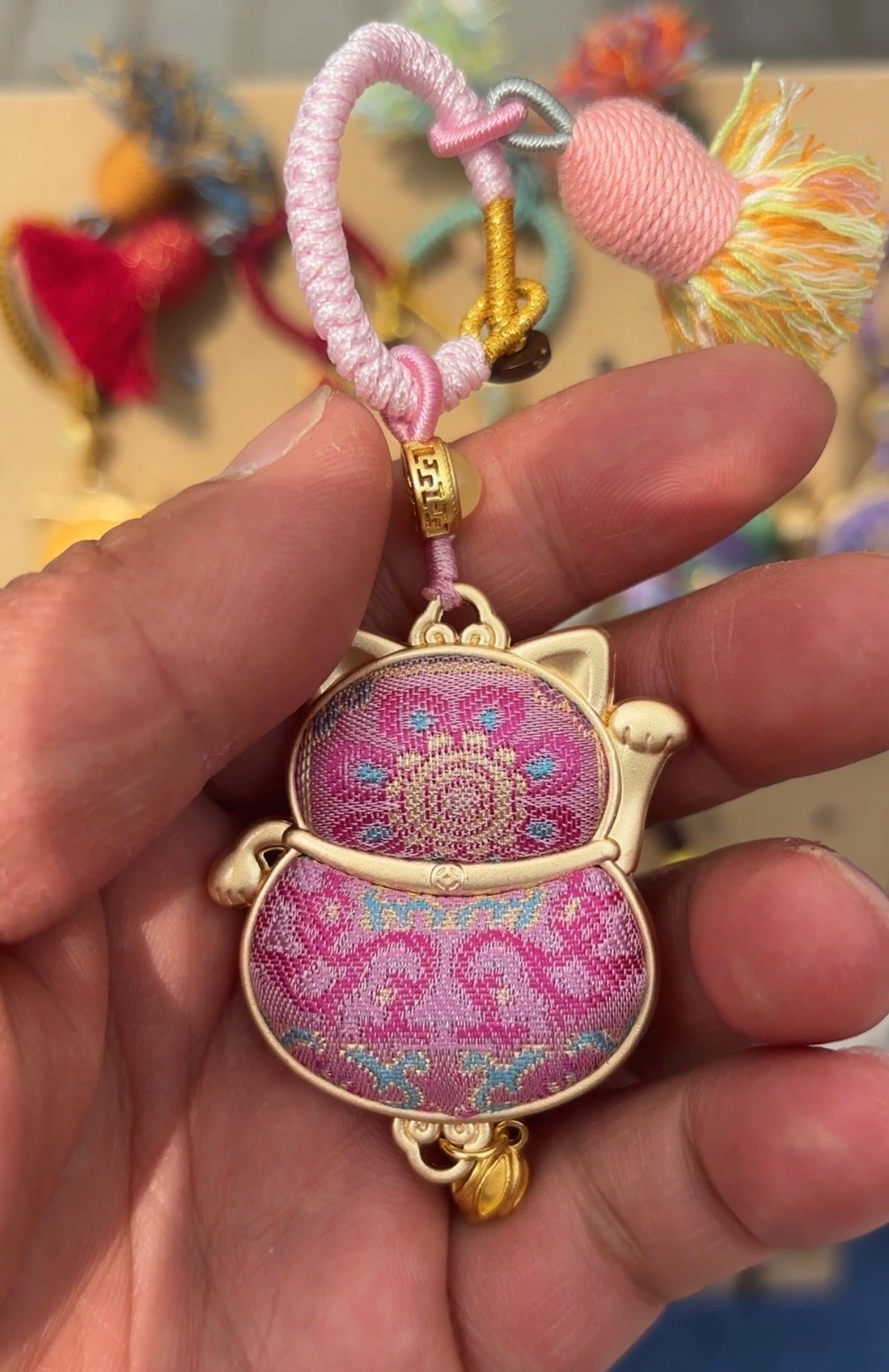 Pink Maneki Neko Lucky Charm handmade Kyoto amulet by JOFAE Kyoto, featuring a smiling cat figure with a gold coin and red collar.