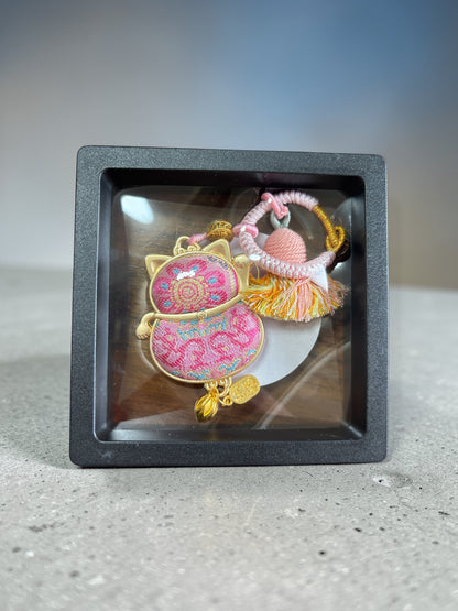 Pink handmade Maneki Neko lucky charm by JOFAE Kyoto, featuring traditional Japanese design and a smiling feline figure.