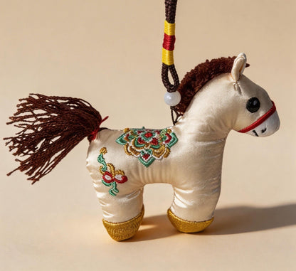 Hand-embroidered ivory Lucky Horse Charm by JOFAE Kyoto, a traditional Japanese amulet symbolizing safe journeys and protection.
