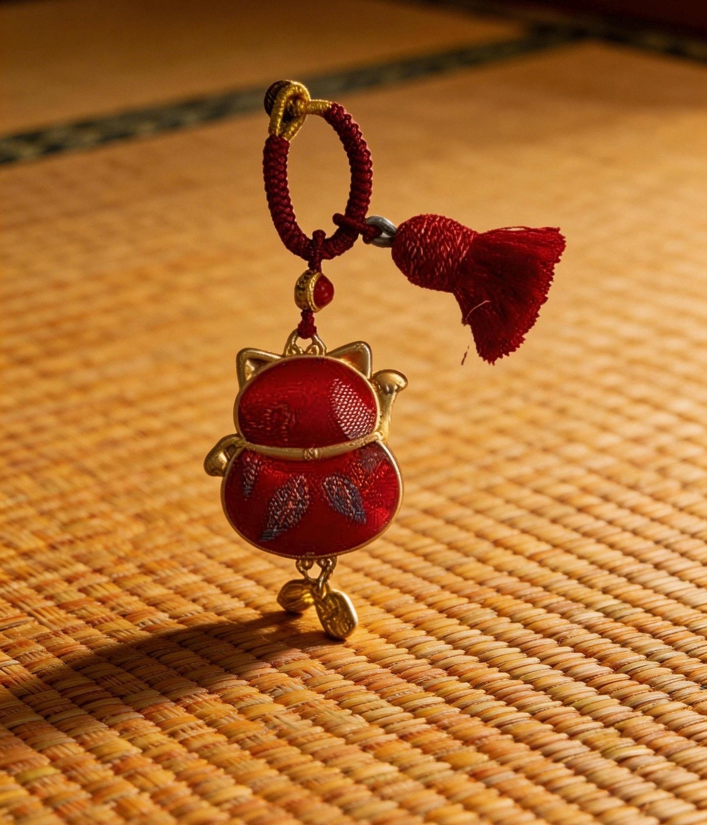 Red Maneki Neko lucky charm by JOFAE Kyoto, traditional Japanese handmade amulet symbolizing wealth, prosperity, and good fortune.