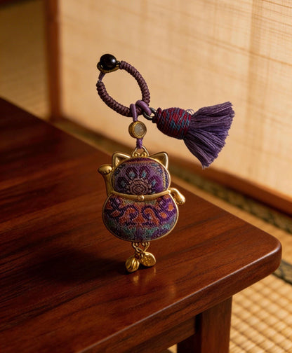 Purple Maneki Neko Lucky Charm from JOFAE Kyoto, handmade Japanese amulet symbolizing protection, wisdom, and inner balance.