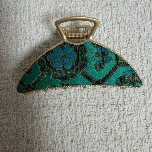 Teal Fan Hair Claw Clip by JOFAE Kyoto. Broad fan-shaped silhouette; Teal and blue floral pattern; Textured gold-tone border; Claw fastening.